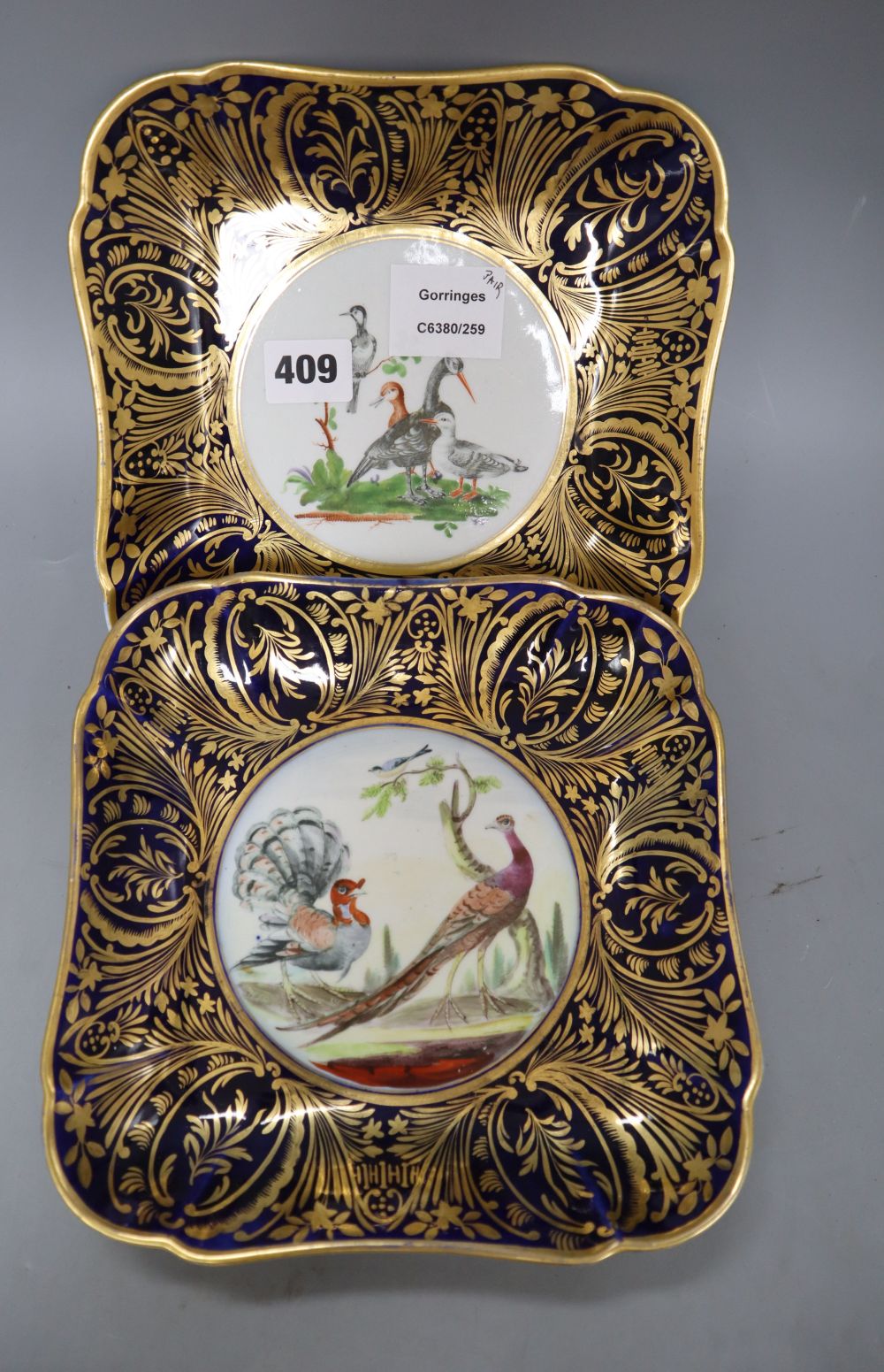 A pair of Derby square shaped dessert dishes, painted with exotic birds, width 20.5cm